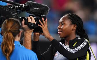 MELBOURNE, AUSTRALIA - JANUARY 20: Coco Gauff of the United States of America signs an autograph after winning her Women's Singles first round match against Venus Williams of the United States of America on day one of the 2020 Australian Open at Melbourne Park on January 20, 2020 in Melbourne, Australia. (Photo by Hannah Peters/Getty Images)