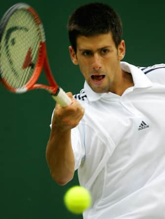 LONDON, United Kingdom:  Novak Djokovic of Serbia and Montenegro hits a forehand to Sebastien Grosjean of France during their match at the 119th Wimbledon Tennis Championships in London, 25 June, 2005.  AFP PHOTO/ODD ANDERSEN  (Photo credit should read ODD ANDERSEN/AFP via Getty Images)