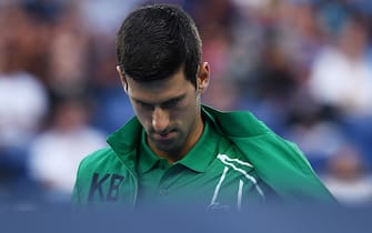 MELBOURNE, AUSTRALIA - JANUARY 28: Novak Djokovic of Serbia looks on before his Men s Singles Quarterfinal match against Milos Raonic of Canada on day nine of the 2020 Australian Open at Melbourne Park on January 28, 2020 in Melbourne, Australia. (Photo by Hannah Peters/Getty Images)