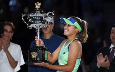 Sofia Kenin of the US poses with the trophy after winning against Spain's Garbine Muguruza in their women's singles final match on day thirteen of the Australian Open tennis tournament in Melbourne on February 1, 2020. (Photo by Greg Wood / AFP) / IMAGE RESTRICTED TO EDITORIAL USE - STRICTLY NO COMMERCIAL USE (Photo by GREG WOOD/AFP via Getty Images)