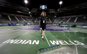 INDIAN WELLS, CALIFORNIA - MARCH 08:  Courtmaster Jeffrey Brooker cleans the center court at the Indian Wells Tennis Garden on March 08, 2020 in Indian Wells, California. The BNP Paribas Open was cancelled by the Riverside County Public Health Department, as county officials declared a public health emergency when a case of coronavirus (COVID-19) was confirmed in the area. (Photo by Al Bello/Getty Images)