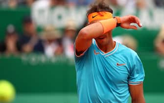 1143947607 MONTE-CARLO, MONACO - APRIL 20: Rafael Nadal of Spain shows his dejection during his straight sets defeat by Fabio Fognini of Italy in their semifinal match during day seven of the Rolex Monte-Carlo Masters at Monte-Carlo Country Club on April 20, 2019 in Monte-Carlo, Monaco. (Photo by Clive Brunskill/Getty Images)