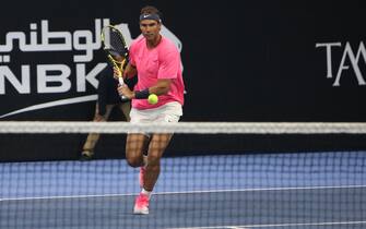 Rafael Nadal of Spain sets off to return the ball to retired compatriot David Ferrer (unseen) during an exhibition game to inaugurate the Rafa Nadal Academy Kuwait, at Shaikh Jaber Al Abdullah Al Jaber Al Sabah International Tennis Complex in the Kuwaiti capital, on February 5, 2020. (Photo by Yasser Al-Zayyat / AFP) (Photo by YASSER AL-ZAYYAT/AFP via Getty Images)