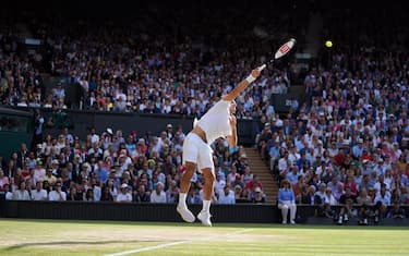 epa07717118 Roger Federer of Switzerland serves to Novak Djokovic of Serbia in the men's final of the Wimbledon Championships at the All England Lawn Tennis Club, in London, Britain, 14 July 2019. EPA/NIC BOTHMA EDITORIAL USE ONLY/NO COMMERCIAL SALES