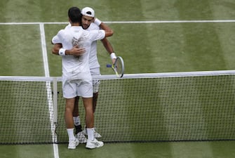 epa09337749 Novak Djokovic of Serbia shakes hands with Matteo Berrettini of Italy after winning the men's final at the Wimbledon Championships, Wimbledon, Britain 11 July 2021.  EPA/Peter Nicholls / POOL   EDITORIAL USE ONLY