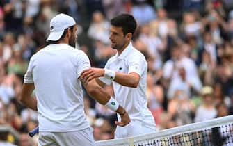 epa09338049 Novak Djokovic of Serbia shakes hands with Matteo Berrettini of Italy after winning the men's final at the Wimbledon Championships, Wimbledon, Britain 11 July 2021.  EPA/NEIL HALL   EDITORIAL USE ONLY