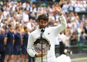 epa09337855 Matteo Berrettini of Italy waves while holding the runners-up trophy after loosing the men's final against Novak Djokovic of Serbia at the Wimbledon Championships, Wimbledon, Britain 11 July 2021.  EPA/NEIL HALL   EDITORIAL USE ONLY