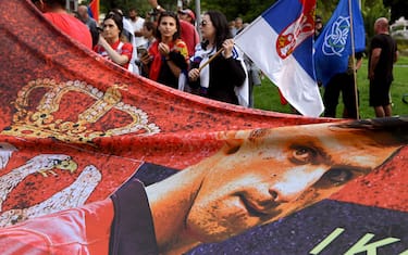 Members of the local Serbian community hold flags and banners outside a government detention centre where Serbia's tennis champion Novak Djokovic is staying in Melbourne on January 8, 2022, after he was dramatically refused entry to Australia over his Covid-19 vaccine status. (Photo by William WEST / AFP) (Photo by WILLIAM WEST/AFP via Getty Images)