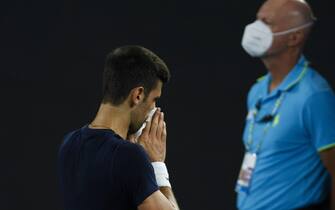 MELBOURNE, AUSTRALIA - JANUARY 14: Novak Djokovic of Serbia blows his nose during a practice session ahead of the 2022 Australian Open at Melbourne Park on January 14, 2022 in Melbourne, Australia. (Photo by Daniel Pockett/Getty Images)
