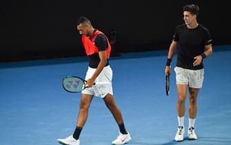 Australia's Nick Kyrgios (L) and Australia's Thanasi Kokkinakis react as they play against Australia's Matthew Ebden and Australia's Max Purcell during their men's doubles final match on day thirteen of the Australian Open tennis tournament in Melbourne on January 29, 2022. - -- IMAGE RESTRICTED TO EDITORIAL USE - STRICTLY NO COMMERCIAL USE -- (Photo by William WEST / AFP) / -- IMAGE RESTRICTED TO EDITORIAL USE - STRICTLY NO COMMERCIAL USE -- (Photo by WILLIAM WEST/AFP via Getty Images)