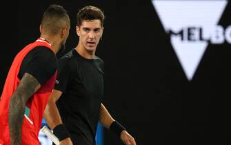 Australia's Thanasi Kokkinakis (R) and compatriot Nick Kyrgios confer as they play against Australia's Matthew Ebden and compatriot Max Purcell during their men's doubles final match on day thirteen of the Australian Open tennis tournament in Melbourne on January 29, 2022. - -- IMAGE RESTRICTED TO EDITORIAL USE - STRICTLY NO COMMERCIAL USE -- (Photo by Aaron FRANCIS / AFP) / -- IMAGE RESTRICTED TO EDITORIAL USE - STRICTLY NO COMMERCIAL USE -- (Photo by AARON FRANCIS/AFP via Getty Images)