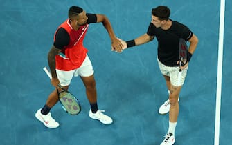 MELBOURNE, AUSTRALIA - JANUARY 29: Nick Kyrgios (L) of Australia and Thanasi Kokkinakis of Australia celebrate a point in their Men's Doubles Final match against Matthew Ebden of Australia and Max Purcell of Australia during day 13 of the 2022 Australian Open at Melbourne Park on January 29, 2022 in Melbourne, Australia. (Photo by Clive Brunskill/Getty Images)