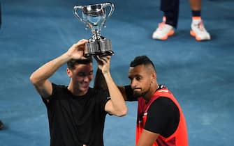 Australia's Thanasi Kokkinakis (L) and Australia's Nick Kyrgios pose with the trophy after winning against Australia's Matthew Ebden and Australia's Max Purcell during their men's doubles final match on day thirteen of the Australian Open tennis tournament in Melbourne on January 29, 2022. - -- IMAGE RESTRICTED TO EDITORIAL USE - STRICTLY NO COMMERCIAL USE -- (Photo by William WEST / AFP) / -- IMAGE RESTRICTED TO EDITORIAL USE - STRICTLY NO COMMERCIAL USE -- (Photo by WILLIAM WEST/AFP via Getty Images)