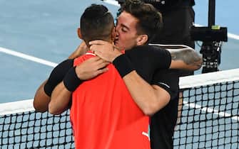 Australia's Thanasi Kokkinakis (R) and Australia's Nick Kyrgios react after winning against Australia's Matthew Ebden and Australia's Max Purcell during their men's doubles final match on day thirteen of the Australian Open tennis tournament in Melbourne on January 29, 2022. - -- IMAGE RESTRICTED TO EDITORIAL USE - STRICTLY NO COMMERCIAL USE -- (Photo by William WEST / AFP) / -- IMAGE RESTRICTED TO EDITORIAL USE - STRICTLY NO COMMERCIAL USE -- (Photo by WILLIAM WEST/AFP via Getty Images)