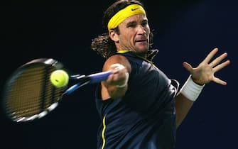BEIJING - SEPTEMBER 14: Carlos Moya of Spain returns during the men's second round of the China Open against Stefan Koubek of Austria at Beijing Tennis Center on September 14, 2005 in Beijing, China.  (Photo by Guang Niu/Getty Images)