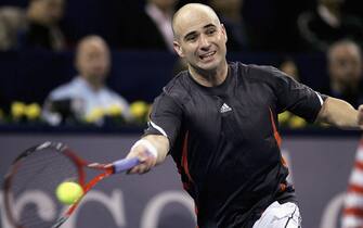 SHANGHAI - NOVEMBER 14:  Andre Agassi of the USA plays a forehand during his straight sets defeat against Nikolay Davydenko of Russia in his first match of the round robin, at the Tennis Masters Cup, at the Qi Zhong Stadium , November 14, 2005 in Shanghai, China. (Photo by Clive Brunskill/Getty Images)    
