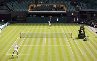 Rafael Nadal (top of court) and Matteo Berrettini practice on centre court ahead of the 2022 Wimbledon Championship at the All England Lawn Tennis and Croquet Club, Wimbledon. Picture date: Thursday June 23, 2022.