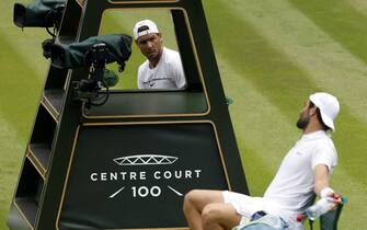 Rafael Nadal (top) and Matteo Berrettini have a discussion as they practice on centre court ahead of the 2022 Wimbledon Championship at the All England Lawn Tennis and Croquet Club, Wimbledon. Picture date: Thursday June 23, 2022.