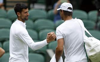 Rafael Nadal and Novak Djokovic (left) greet each other on centre court ahead of the 2022 Wimbledon Championship at the All England Lawn Tennis and Croquet Club, Wimbledon. Picture date: Thursday June 23, 2022.