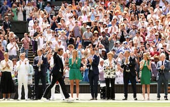 LONDON, ENGLAND - JULY 03: Roger Federer of Switzerland walks past former champions during the Centre Court Centenary Celebration on day seven of The Championships Wimbledon 2022 at All England Lawn Tennis and Croquet Club on July 03, 2022 in London, England. (Photo by Ryan Pierse/Getty Images)