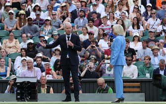 Presenters of the Centre Court Centenary Ceremony, US former tennis player John McEnroe (L) and BBC journalist Sue Baker conduct the previous show to the round of 16 women's singles tennis match between Britain's Heather Watson and Germany's Jule Niemeier during their  on the seventh day of the 2022 Wimbledon Championships at The All England Tennis Club in Wimbledon, southwest London, on July 3, 2022. - RESTRICTED TO EDITORIAL USE (Photo by Adrian DENNIS / AFP) / RESTRICTED TO EDITORIAL USE (Photo by ADRIAN DENNIS/AFP via Getty Images)