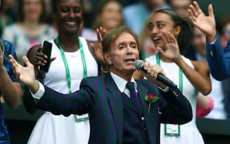 Bristish singer Cliff Richard performs during the Centre Court Centenary Ceremony, on the seventh day of the 2022 Wimbledon Championships at The All England Tennis Club in Wimbledon, southwest London, on July 3, 2022. - RESTRICTED TO EDITORIAL USE (Photo by Adrian DENNIS / AFP) / RESTRICTED TO EDITORIAL USE (Photo by ADRIAN DENNIS/AFP via Getty Images)
