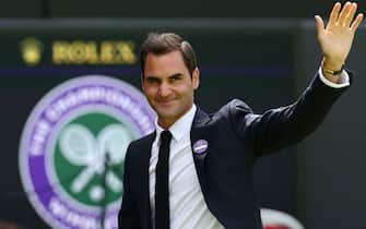 Swiss former tennis player Roger Federer waves during the Centre Court Centenary Ceremony, on the seventh day of the 2022 Wimbledon Championships at The All England Tennis Club in Wimbledon, southwest London, on July 3, 2022. - RESTRICTED TO EDITORIAL USE (Photo by Adrian DENNIS / AFP) / RESTRICTED TO EDITORIAL USE (Photo by ADRIAN DENNIS/AFP via Getty Images)
