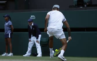 Nick Kyrgios tries to return through his legs during his Men's Singles third round match against Stefanos Tsitsipas during day six of the 2022 Wimbledon Championships at the All England Lawn Tennis and Croquet Club, Wimbledon. Picture date: Saturday July 2, 2022.