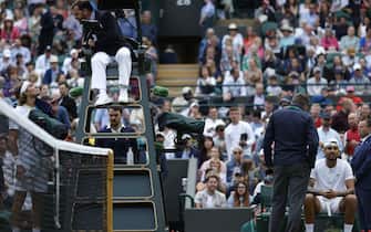Nick Kyrgios (right) speaks an official after the second set as Stefanos Tsitsipas (left) speaks to the umpire during their Men's Singles third round match during day six of the 2022 Wimbledon Championships at the All England Lawn Tennis and Croquet Club, Wimbledon. Picture date: Saturday July 2, 2022.