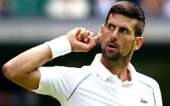 Serbia's Novak Djokovic puts his ear to the crowd in his match against Italy's Jannik Sinner in the quarter finals match on centre court on day nine of the 2022 Wimbledon Championships at the All England Lawn Tennis and Croquet Club, Wimbledon. Picture date: Tuesday July 5, 2022.