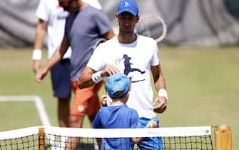Novak Djokovic with his son Stefan ahead of a practice session on day thirteen of the 2022 Wimbledon Championships at the All England Lawn Tennis and Croquet Club, Wimbledon. Picture date: Saturday July 9, 2022.