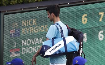 epa05851018 Novak Djokovic of Serbia walks off the court after losing to Nick Kyrgios of Australia in their match at the 2017 BNP Paribas Open tennis tournament at the Indian Wells Tennis Garden in Indian Wells, California, USA 15 March 2017.  EPA/LARRY W. SMITH