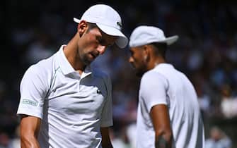 Serbia's Novak Djokovic (L) walks past Australia's Nick Kyrgios during their men's singles final tennis match on the fourteenth day of the 2022 Wimbledon Championships at The All England Tennis Club in Wimbledon, southwest London, on July 10, 2022. - RESTRICTED TO EDITORIAL USE (Photo by SEBASTIEN BOZON / AFP) / RESTRICTED TO EDITORIAL USE (Photo by SEBASTIEN BOZON/AFP via Getty Images)