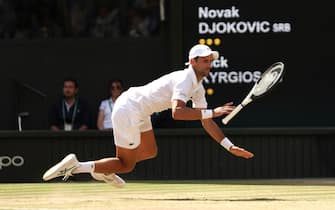 LONDON, ENGLAND - JULY 10: Novak Djokovic of Serbia falls against Nick Kyrgios of Australia during their Men's Singles Final match on day fourteen of The Championships Wimbledon 2022 at All England Lawn Tennis and Croquet Club on July 10, 2022 in London, England. (Photo by Clive Brunskill/Getty Images)