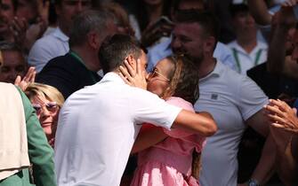 Serbia's Novak Djokovic kisses his wife Jelena Ristic after beating Australia's Nick Kyrgios during their men's singles final tennis match on the fourteenth day of the 2022 Wimbledon Championships at The All England Tennis Club in Wimbledon, southwest London, on July 10, 2022. - RESTRICTED TO EDITORIAL USE (Photo by Adrian DENNIS / AFP) / RESTRICTED TO EDITORIAL USE (Photo by ADRIAN DENNIS/AFP via Getty Images)