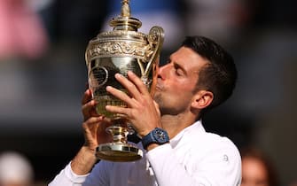 LONDON, ENGLAND - JULY 10: Novak Djokovic of Serbia kisses the trophy following his victory against Nick Kyrgios of Australia during their Men's Singles Final match on day fourteen of The Championships Wimbledon 2022 at All England Lawn Tennis and Croquet Club on July 10, 2022 in London, England. (Photo by Ryan Pierse/Getty Images)