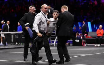 Stewards remove a protester after setting fire to the court on day one of the Laver Cup at the O2 Arena, London. Picture date: Friday September 23, 2022.