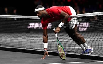 Frances Tiafoe rests on the net against Stefanos Tsitsipas in the singles match on day three of the Laver Cup at the O2 Arena, London. Picture date: Sunday September 25, 2022.