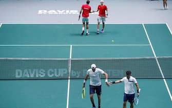 epa08007199 Italy's tennis players Fabio Fognini (down, R) and Matteto Berrettini (down, L) and Canada's Denis Shapovalov (up, R) and Vasek Podpisil (up, L) during a men doubles match of the Davis Cup finals played at the Caja Magica facilities in Madrid, Spain, 18 November 2019. The 2019 Davis Cup finals will take place from 18 to 24 November 2019 in Madrid.  EPA/EMILIO NARANJO