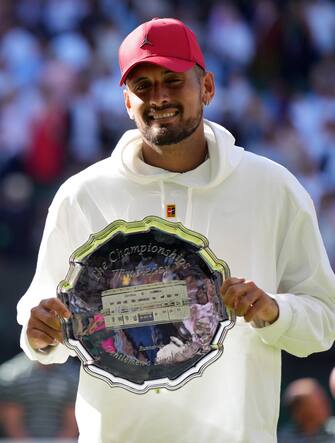 Wimbledon Champion Novak Djokovic with his trophy alongside runner up Nick Kyrgios following The Final of the Gentlemen's Singles on day fourteen of the 2022 Wimbledon Championships at the All England Lawn Tennis and Croquet Club, Wimbledon. Picture date: Sunday July 10, 2022.