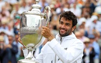 Matteo Berrettini celebrates with his trophy after winning the final against Filip Krajinovic on day seven of the cinch Championships at The Queen's Club, London. Picture date: Sunday June 19, 2022.