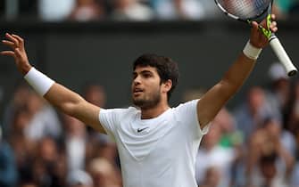 epa10742257 Carlos Alcaraz of Spain reacts after winning his Men's Singles quarter-finals match against Holger Rune of Denmark at the Wimbledon Championships, Wimbledon, Britain, 12 July 2023.  EPA/ISABEL INFANTES   EDITORIAL USE ONLY