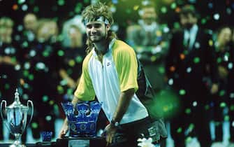 FRANKFURT - NOVEMBER 1:  Andre Agassi of the USA celebrates with the trophy after the final match at the ATP Masters on November 1, 1990 in Frankfurt, Germany.    (Photo by Bongarts/Getty Images)