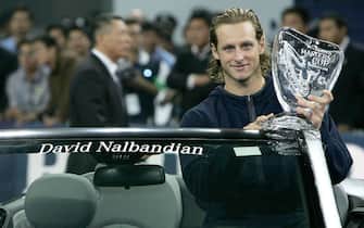 SHANGHAI, CHINA - NOVEMBER 20:  David Nalbandian of Argentina holds the trophy after his five set victory against Roger Federer of Switzerland in the final on November 20, 2005 at the Qi Zhong Stadium in Shanghai, China. (Photo by Clive Brunskill/Getty Images)