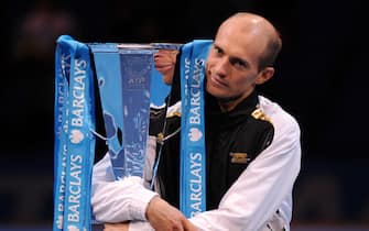 Nikolay Davydenko of Russia celebrates with the trophy after beating Juan Martin Del Potro of Argentina in the singles final match during the Barclays ATP World Tour Tennis Finals in London, on November 29, 2009. AFP PHOTO/CARL DE SOUZA (Photo credit should read CARL DE SOUZA/AFP via Getty Images)