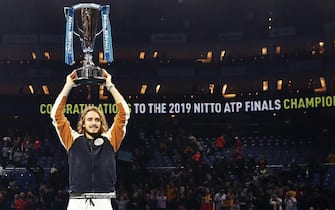 LONDON, ENGLAND - NOVEMBER 17:  Stefanos Tsitsipas of Greece celebrates with the trophy after his singles final match victory against Dominic Thiem of Austria during Day Eight of the Nitto ATP Finals at The O2 Arena on November 17, 2019 in London, England. (Photo by Julian Finney/Getty Images)