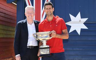 epa09028955 Novak Djokovic (R) of Serbia poses for photographs with Australian Open Tournament Director Craig Tiley (L) on Brighton Beach with the Norman Brookes Challenge Cup following his men's singles finals win against Daniil Medvedev of Russia at the Australian Open grand slam tennis tournament, in Melbourne, Australia, 22 February 2021.  EPA/DAVE HUNT AUSTRALIA AND NEW ZEALAND OUT