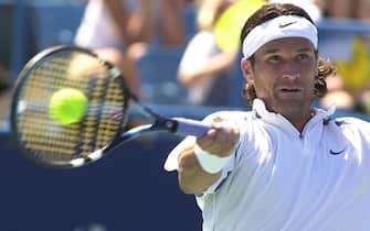 CINCINNATI, UNITED STATES:  Carlos Moya of Spain performs a forehand against Rainer Schuettler of Germany during the quarterfinals of the Tennis Masters-Series  in Cincinnati  09 August, 2002.  Moya won the match 7-6, 6-1. AFP PHOTO/Mike SIMONS (Photo credit should read MIKE SIMONS/AFP via Getty Images)