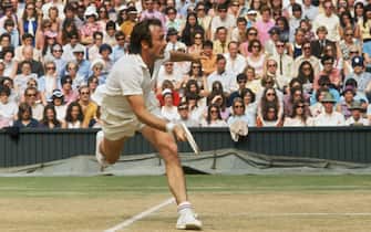Australian tennis player John Newcombe in action against Stan Smith of the USA, during the Men's Singles final at the Wimbledon Lawn Tennis Championships, London, 5th July 1971. Newcombe won the match over 5 sets. (Photo by Frank Tewkesbury/Daily Express/Hulton Archive/Getty Images)
