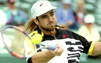 Andre Agassi of the U.S. hits a forehand to Jason Stoltenberg of Australia in first set action at the Lipton International Championships before rain delayed the game 16 March 1993. Agassi was leading (Photo by DOUG COLLIER / AFP)        (Photo credit should read DOUG COLLIER/AFP via Getty Images)